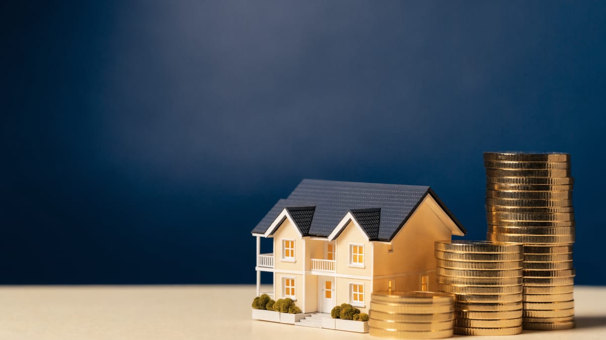 Scale model house beside rising stacks of gold coins, the deposit needed for a rooming house loan